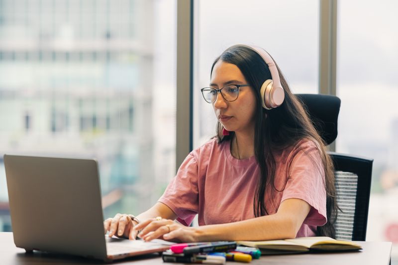 A professional working on a laptop. Stock photography.
