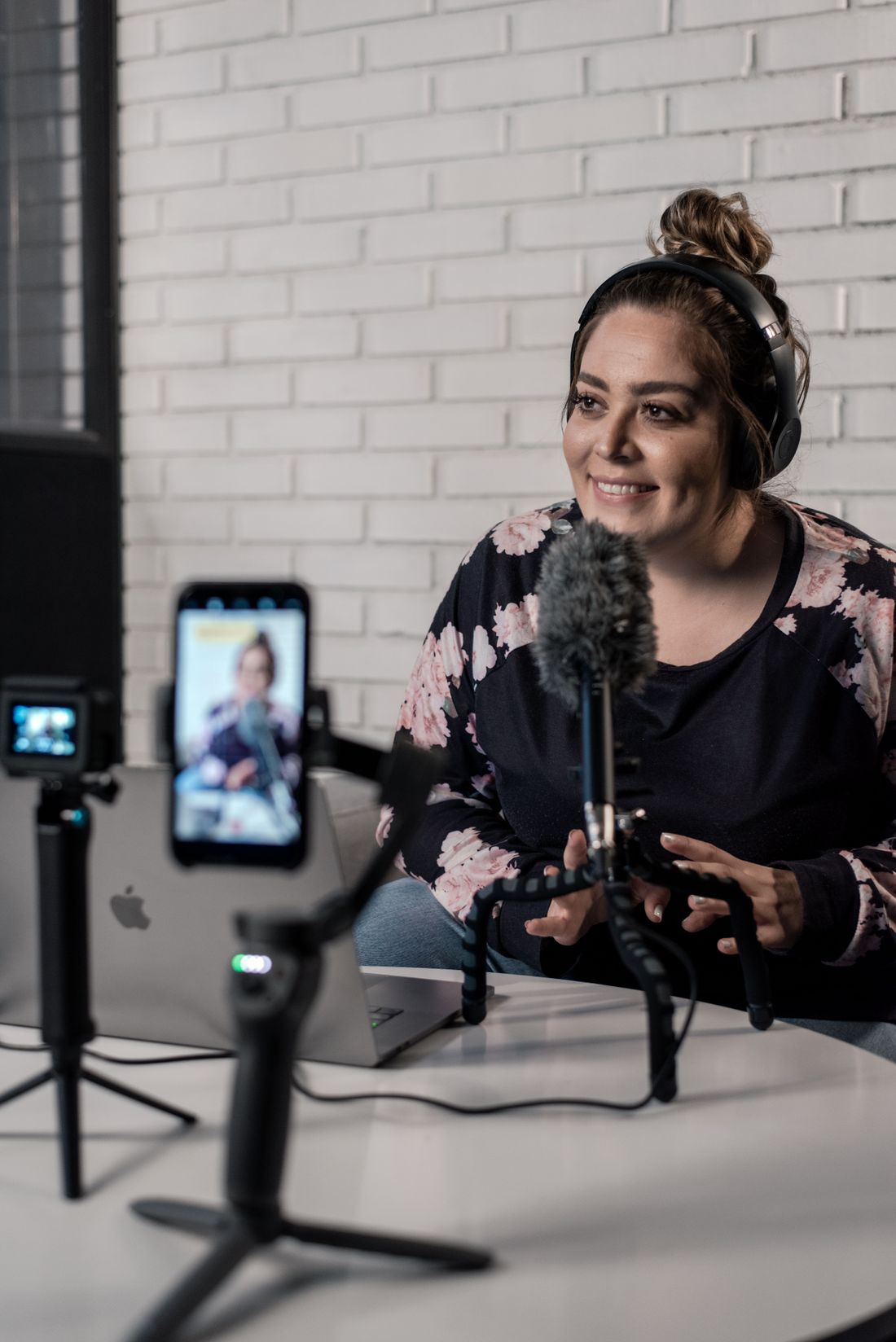 Content creator speaking into a microphone while recording a video. Stock photo.