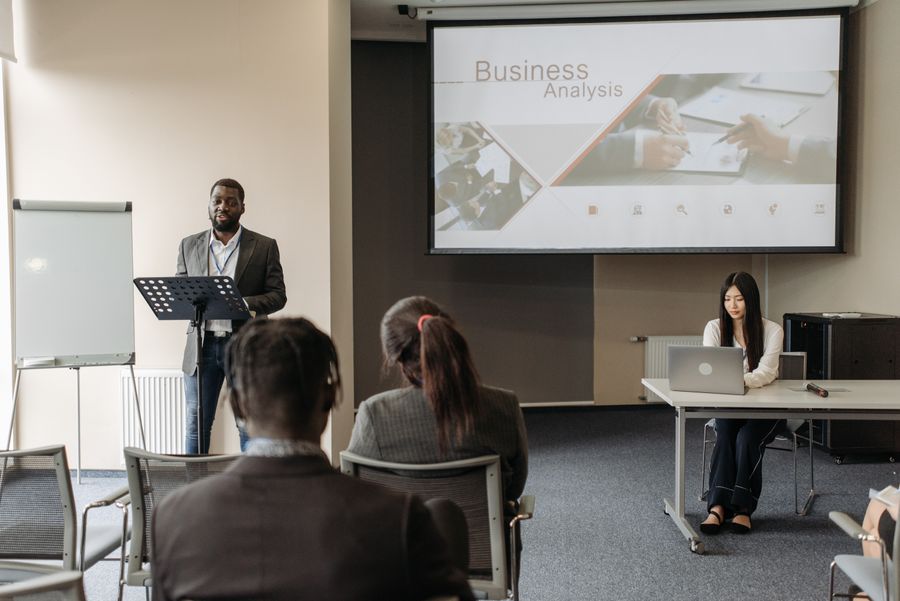 Speaker teaching a group of professionals at a business seminar. Stock photo.